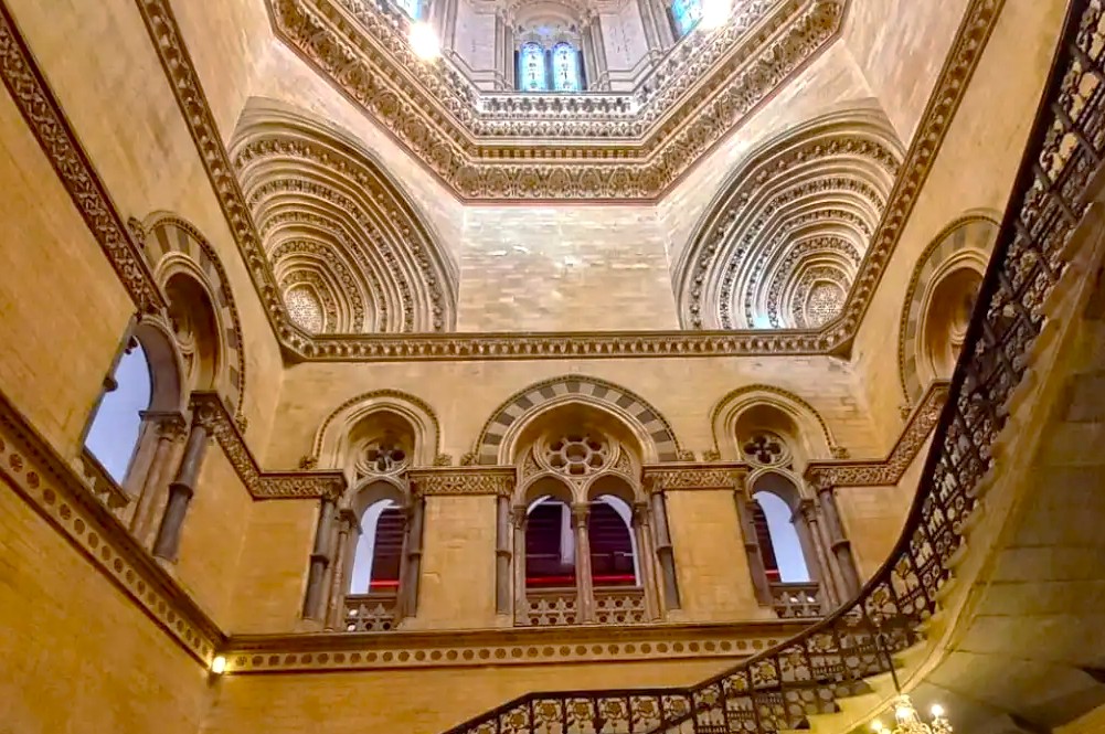 Visitors admire the ornate Gothic interior at Chhatrapati Shivaji Maharaj Terminus (CSMT) station railway landmark in India-Mumbai-Mahapradesh, highlighting heritage craftsmanship, detailed arches, decorative moldings, grand staircase, inspiring cultural tourism experiences. Visitors admire the ornate Gothic interior at Chhatrapati Shivaji Maharaj Terminus (CSMT) station railway landmark in India-Mumbai-Mahapradesh, highlighting heritage craftsmanship, detailed arches, decorative moldings, grand staircase, inspiring cultural tourism experiences.