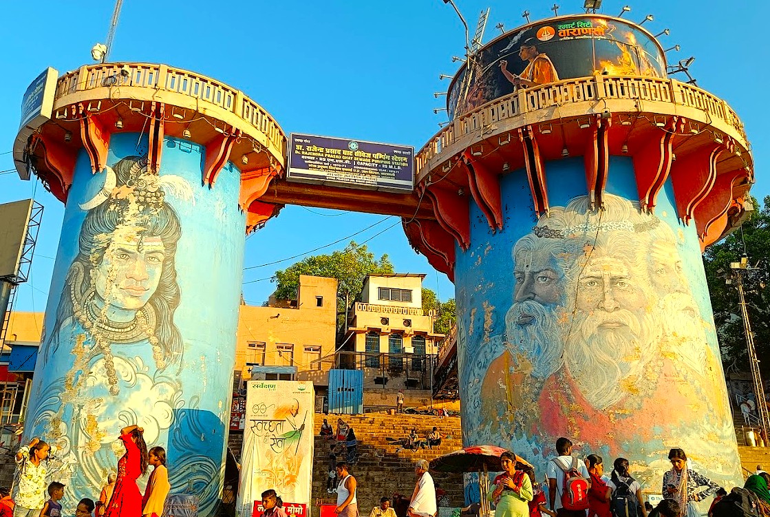 Colorful painted water towers near Dasaswamedh Ghat in Varanasi, India, depict Hindu deities; located close to the UNESCO heritage site Sarnath, a spiritual landmark of religious significance.