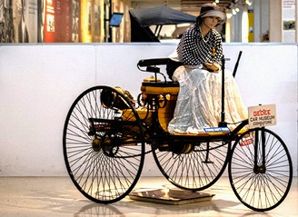 Restored vintage tricycle carriage at Gee Dee Car Museum in Coimbatore, Tamil Nadu, India, highlighting early automotive innovation and historic transport display. Restored vintage tricycle carriage at Gee Dee Car Museum in Coimbatore, Tamil Nadu, India, highlighting early automotive innovation and historic transport display.