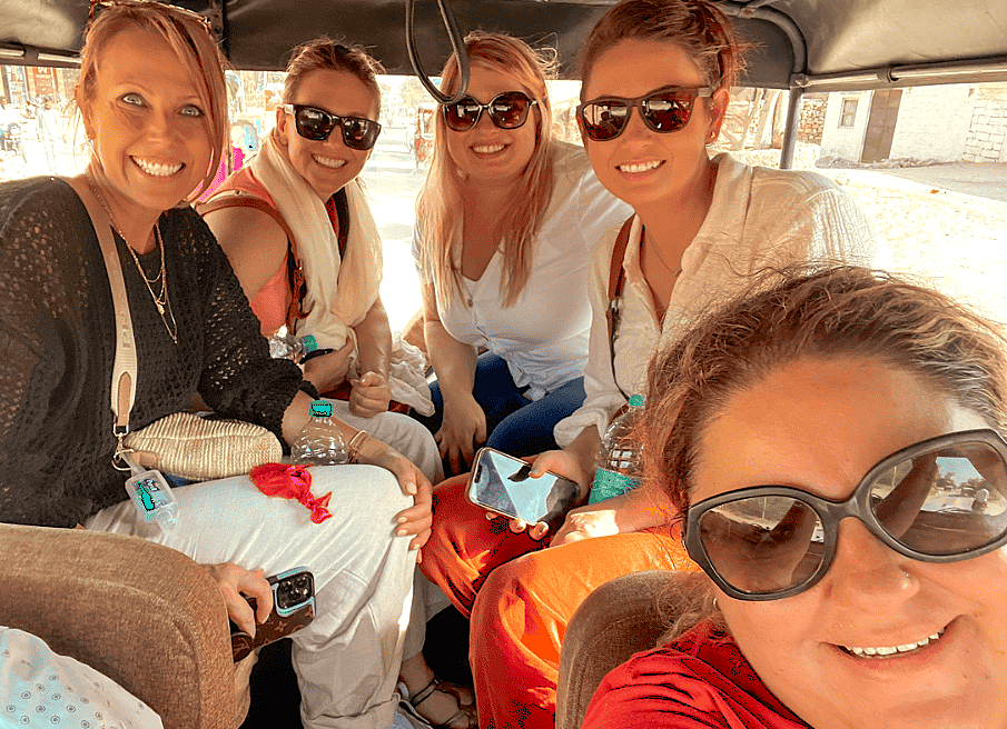 A group of female tourists enjoys a rickshaw tour in Badami, Karnataka, India, visiting historic sites like the Mallikarjuna Temple near the Pattadakal-UNESCO complex. A group of female tourists enjoys a rickshaw tour in Badami, Karnataka, India, visiting historic sites like the Mallikarjuna Temple near the Pattadakal-UNESCO complex.