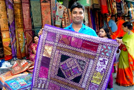 “Artisanal patchwork quilt displayed by a vendor at Devaraja Market in Mysore, Karnataka, India, showcasing vibrant handcrafted textile and traditional Indian craftsmanship.”