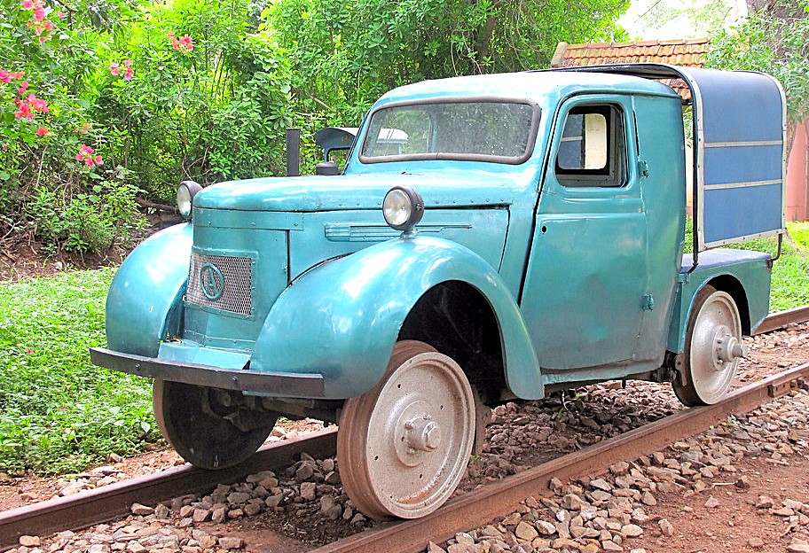 Light blue vintage rail inspection truck displayed outdoors on tracks at Karnataka Railway Museum Mysore, India, shown amidst lush greenery highlighting historical railway preservation. Light blue vintage rail inspection truck displayed outdoors on tracks at Karnataka Railway Museum Mysore, India, shown amidst lush greenery highlighting historical railway preservation.