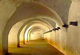 Interior of an arched stone corridor at Srirangapatna Fort in Mysore, Karnataka, India.