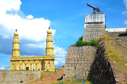 View of historic cannon overlooking temple gopurams at saaint srirangapatna-fort near Mysore in Karnataka, India, showcasing architectural heritage, strategic military legacy, cultural significance, scenic landscape.