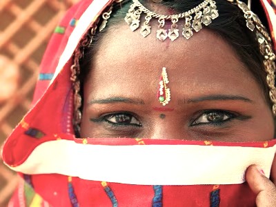 A captivating close-up frames the eyes of a local Indian woman, possibly a bride, in Badami, Karnataka, India, adorned with a bindi and traditional head jewelry. This image captures the rich local culture found near the sacred Agastya Lake and the Pattadakal UNESCO World Heritage site. A captivating close-up frames the eyes of a local Indian woman, possibly a bride, in Badami, Karnataka, India, adorned with a bindi and traditional head jewelry. This image captures the rich local culture found near the sacred Agastya Lake and the Pattadakal UNESCO World Heritage site.