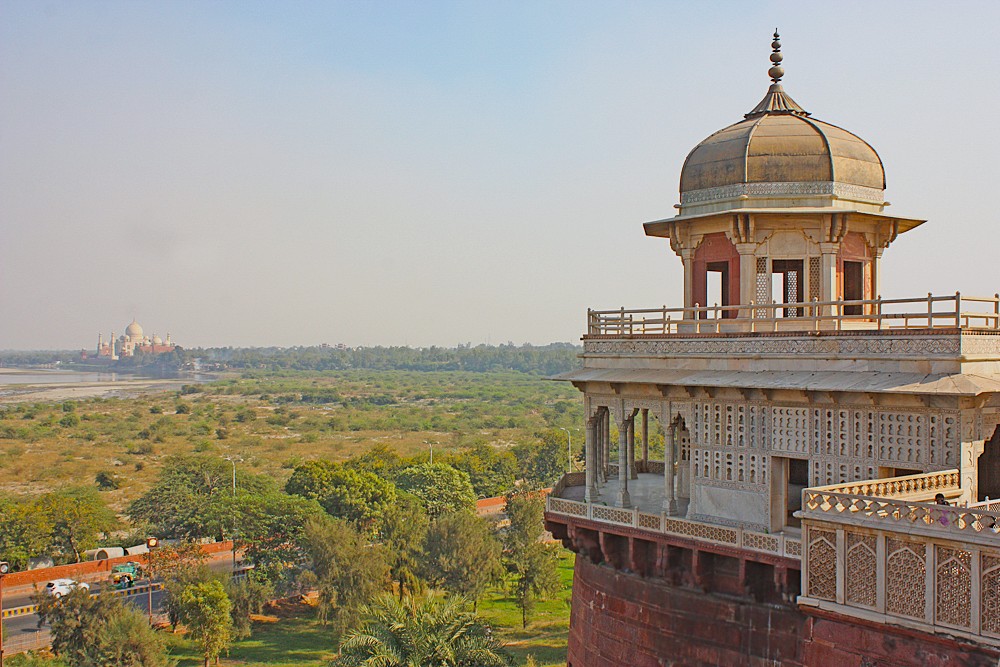"Serene view from Agra Fort balcony reveals distant Taj Mahal and courtyard, unseco World Heritage site in Agra, Uttar Pradesh, India, embodying timeless Mughal grandeur." "Serene view from Agra Fort balcony reveals distant Taj Mahal and courtyard, unseco World Heritage site in Agra, Uttar Pradesh, India, embodying timeless Mughal grandeur."
