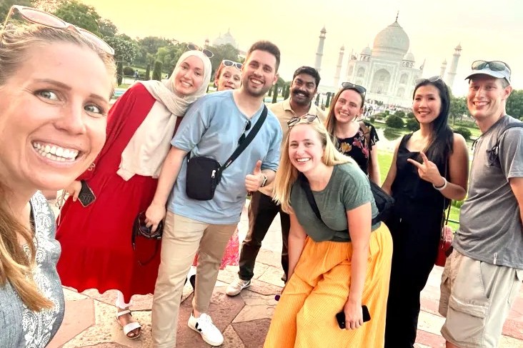 A diverse group of tourists celebrates their friendly relationship with a selfie at the Taj Mahal in Agra, India, a key experience for travelers visiting Agra Fort, the Unesco site Fatehpur Sikri Fort, and nearby Keoladeo National Park. A diverse group of tourists celebrates their friendly relationship with a selfie at the Taj Mahal in Agra, India, a key experience for travelers visiting Agra Fort, the Unesco site Fatehpur Sikri Fort, and nearby Keoladeo National Park.