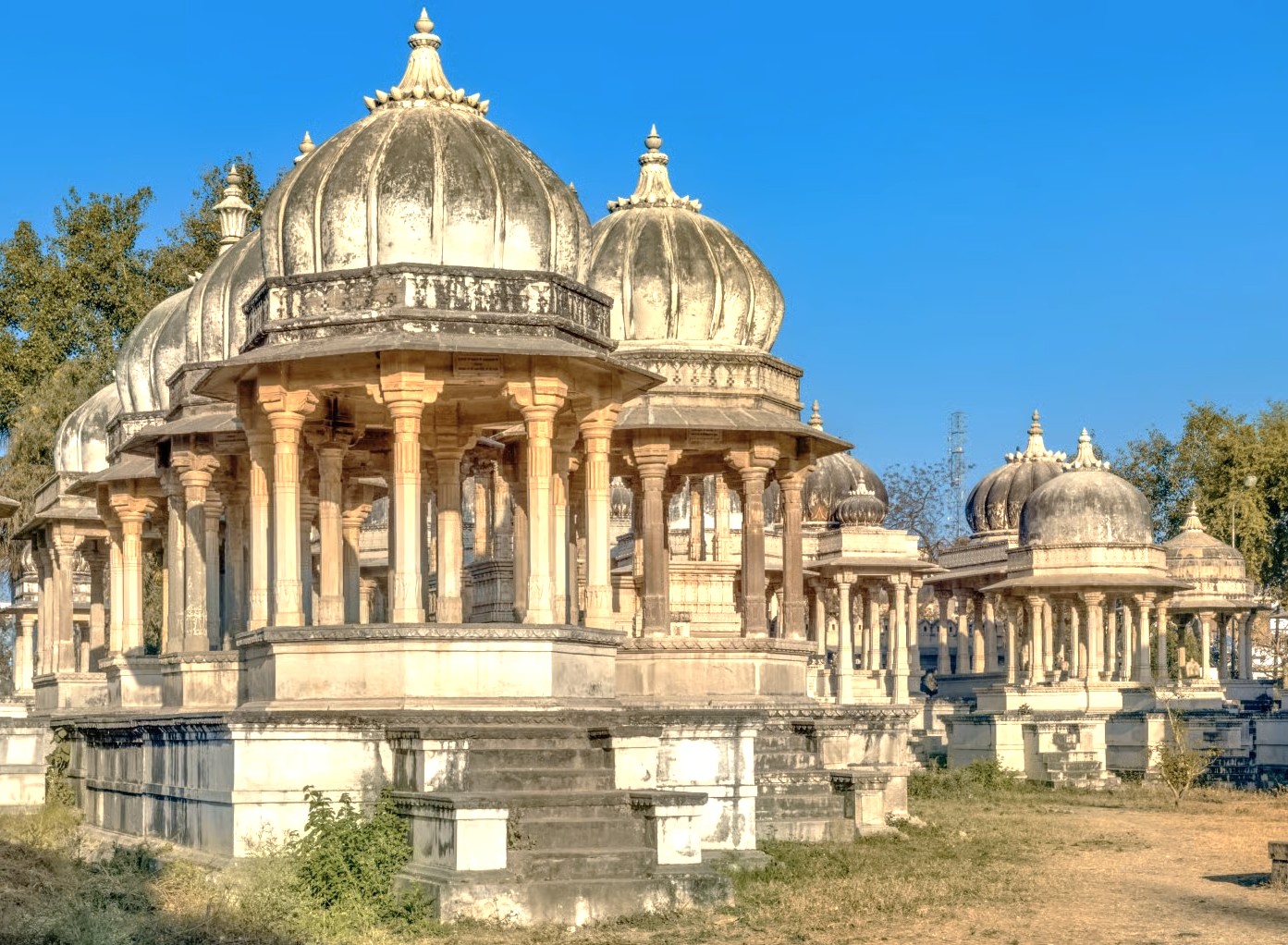 Explore Udaipur’s historic Ahar Cenotaphs in Rajasthan, India, featuring intricately carved marble pavilions, serene riverside gardens, immersive expert-led guided heritage tours, authentic Rajputana architecture, cultural rituals, and panoramic photo opportunities.