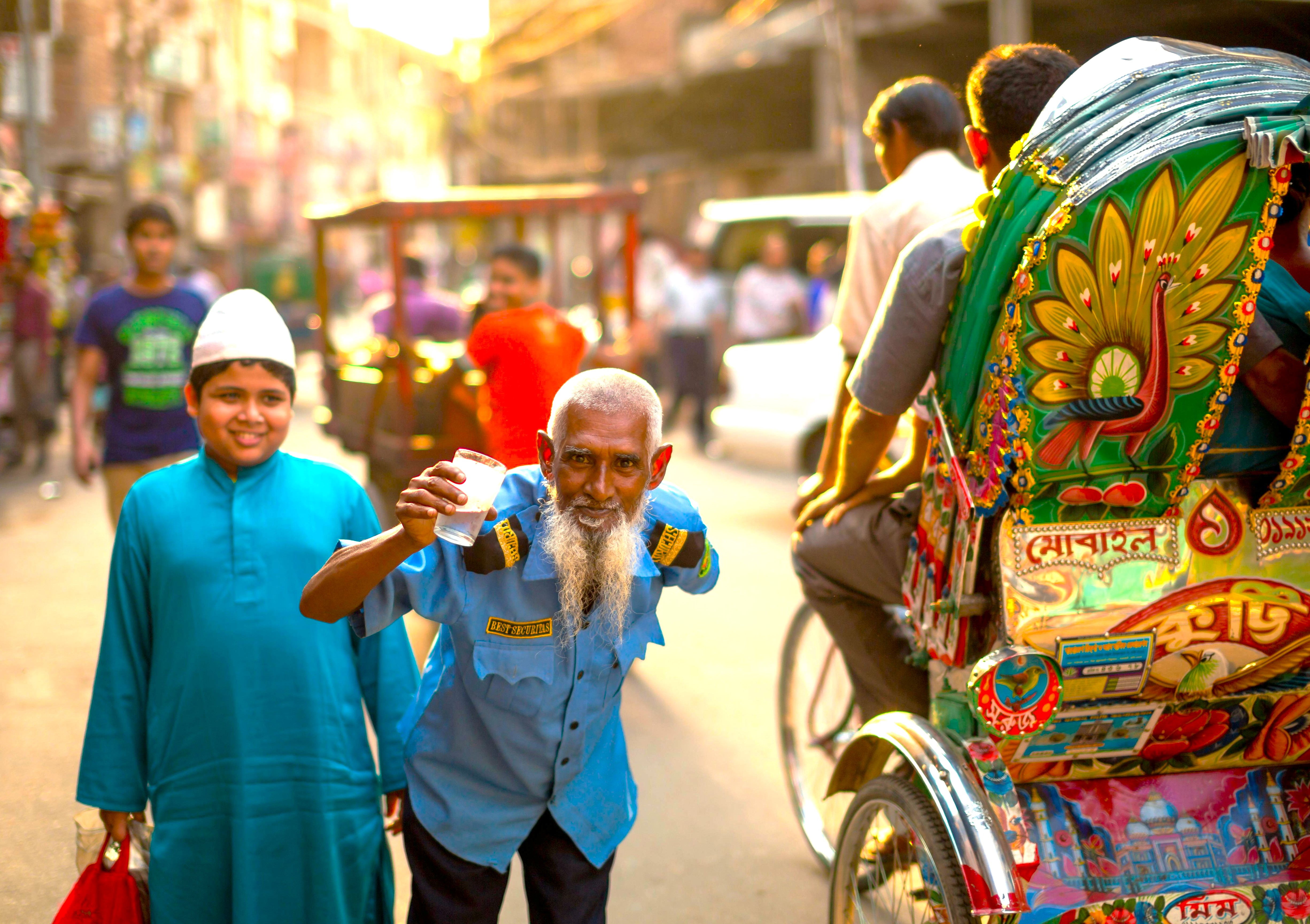 A local man and boy pose by a colorful rickshaw, showcasing daily life in Aihole, India, a key heritage area near Badami and the Pattadakal UNESCO temples. A local man and boy pose by a colorful rickshaw, showcasing daily life in Aihole, India, a key heritage area near Badami and the Pattadakal UNESCO temples.