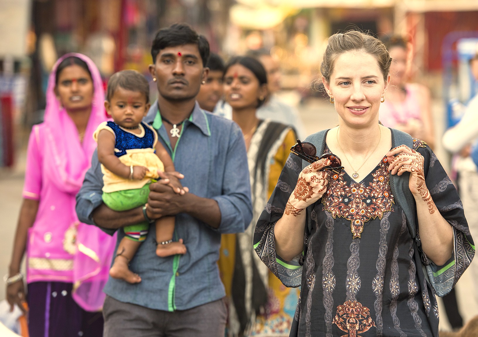 A female tourist with henna tattoos explores the local culture in Aihole, India, a historic village near the heritage sites of Badami and the Pattadakal UNESCO temples. A female tourist with henna tattoos explores the local culture in Aihole, India, a historic village near the heritage sites of Badami and the Pattadakal UNESCO temples.