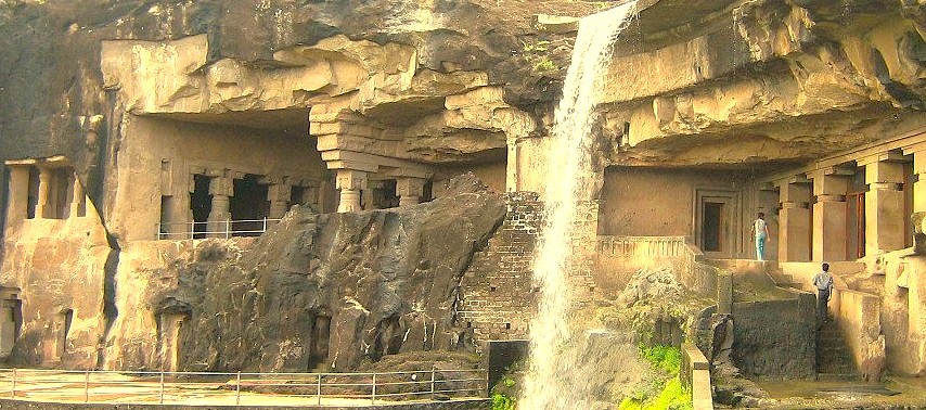 Panoramic view of UNESCO World Heritage rock-cut Elora and Ajanta Caves near Aurangabad, Maharashtra, India, highlighting ancient Buddhist temples carved into basalt cliffs with a cascading waterfall and intricate architecture