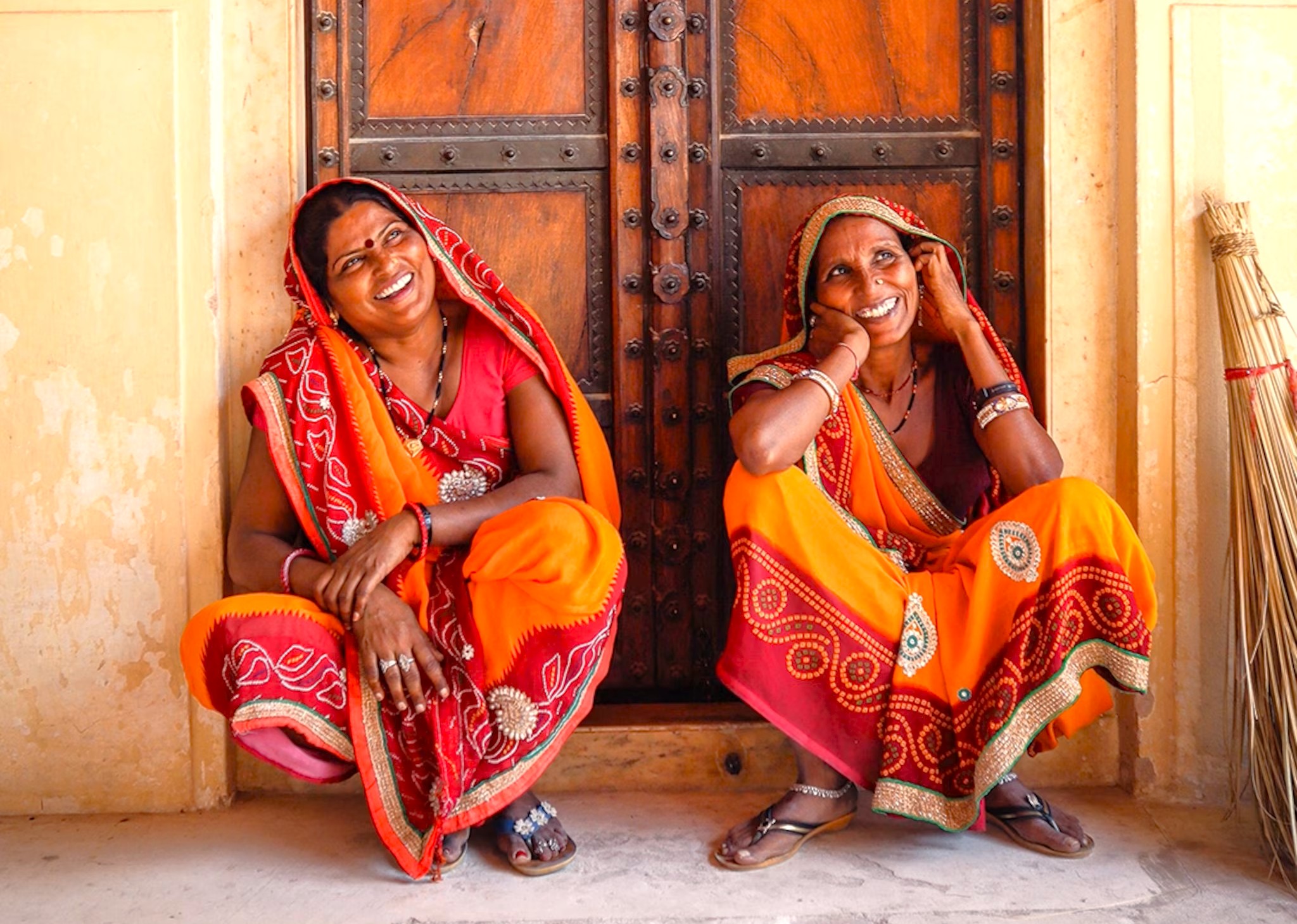 .Two Rajasthani women in vibrant sarees laugh during a break at Amber Fort UNESCO site in Jaipur, Rajasthan, India, showcasing local culture, traditional attire, community life, and rich heritage craftsmanship. .Two Rajasthani women in vibrant sarees laugh during a break at Amber Fort UNESCO site in Jaipur, Rajasthan, India, showcasing local culture, traditional attire, community life, and rich heritage craftsmanship.
