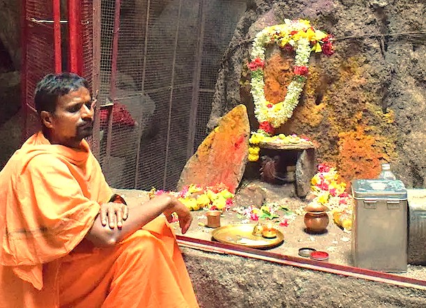 A local pujari tends to a sacred rock altar in Anegundi Village, Karnataka, India, embodying the spiritual life found near the Hampi UNESCO site, a region renowned for its historical wonders like the Queen's Baths, the Vittala Temple, and the majestic Elephant Stables. A local pujari tends to a sacred rock altar in Anegundi Village, Karnataka, India, embodying the spiritual life found near the Hampi UNESCO site, a region renowned for its historical wonders like the Queen's Baths, the Vittala Temple, and the majestic Elephant Stables.