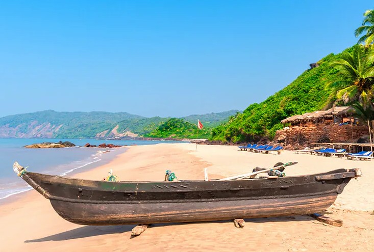 A traditional boat rests on the sand at Anjuna Beach, home of the Anjuna Beach Flee Market, a famous Goa Beaches destination in India, near Karnataka and the Old Goa St. Francis Church UNESCO churches. A traditional boat rests on the sand at Anjuna Beach, home of the Anjuna Beach Flee Market, a famous Goa Beaches destination in India, near Karnataka and the Old Goa St. Francis Church UNESCO churches.