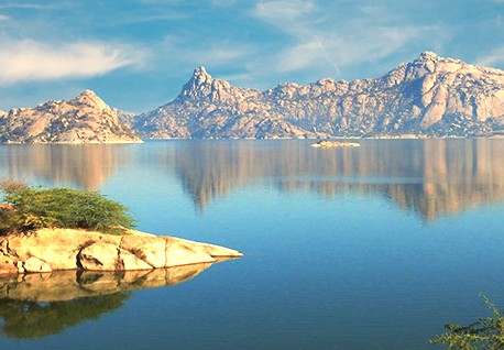 A beautiful lake reflects the ancient Aravali Hills in Rajasthan, India, a proposed UNESCO site offering a natural escape for tourists visiting the historic cities of Jodhpur, Jaipur, and Udaipur. A beautiful lake reflects the ancient Aravali Hills in Rajasthan, India, a proposed UNESCO site offering a natural escape for tourists visiting the historic cities of Jodhpur, Jaipur, and Udaipur.