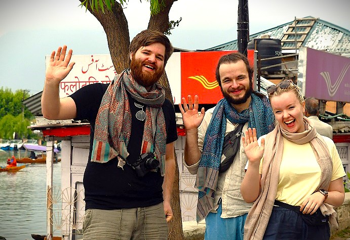 Smiling tourists wave in Srinagar, Jammu and Kashmir, a key location for visiting the Avantiswami Temple, saffron fields, Aru Valley, and Betaab Valley. Smiling tourists wave in Srinagar, Jammu and Kashmir, a key location for visiting the Avantiswami Temple, saffron fields, Aru Valley, and Betaab Valley.