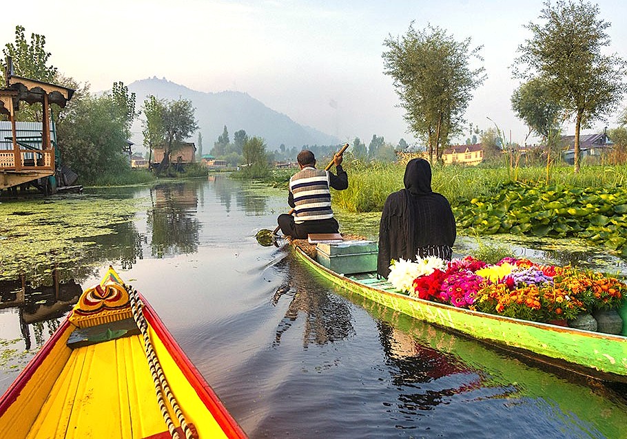 Local flower vendors transport fresh blooms by shikara on Dal Lake in Srinagar, Jammu and Kashmir, near Babu Arts and Craft Emporium, saffron fields, Aru Valley, and Betaab Valley.
