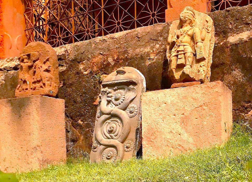 Here is an SEO-optimized sentence based on your request:  Ancient stone sculptures and carvings, including a prominent Naga (serpent) stone, are displayed outside the Badami Archaeological Museum in Badami, Karnataka, India. These priceless artifacts offer a glimpse into the Chalukyan era history preserved near the renowned Pattadakal UNESCO World Heritage site. Here is an SEO-optimized sentence based on your request:  Ancient stone sculptures and carvings, including a prominent Naga (serpent) stone, are displayed outside the Badami Archaeological Museum in Badami, Karnataka, India. These priceless artifacts offer a glimpse into the Chalukyan era history preserved near the renowned Pattadakal UNESCO World Heritage site.