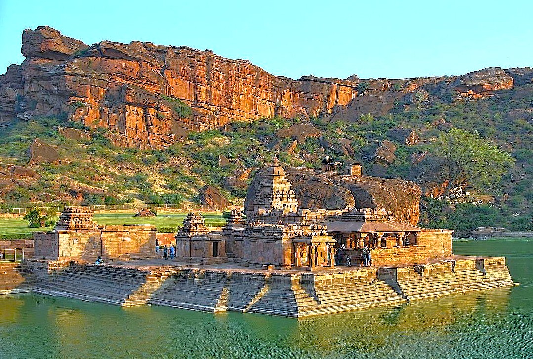Explore the serene Bhuthanatha Temple in Badami, Karnataka, India, set against dramatic red cliffs and the tranquil Agastya Lake. This architectural marvel is a must-visit destination located near the celebrated Pattadakal UNESCO World Heritage site, showcasing stunning Dravidian architecture.