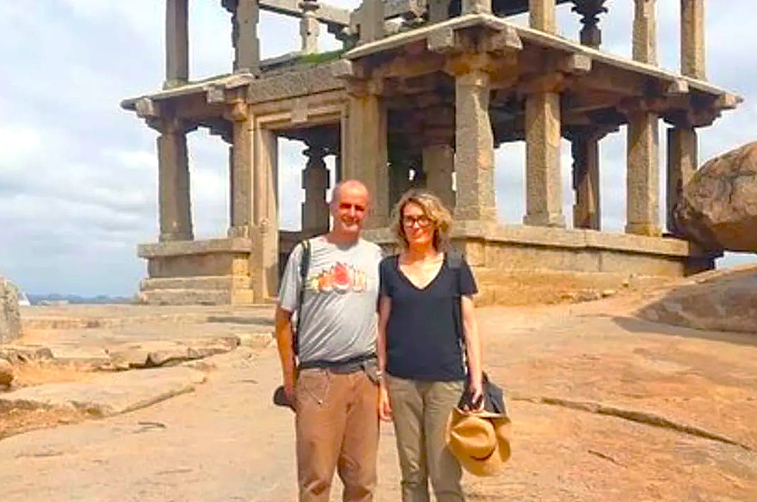 A tourist couple explores the ancient stone temples at Badami Fort in Karnataka, India, a historic heritage site located near the Pattadarkel-Unesco complex. A tourist couple explores the ancient stone temples at Badami Fort in Karnataka, India, a historic heritage site located near the Pattadarkel-Unesco complex.