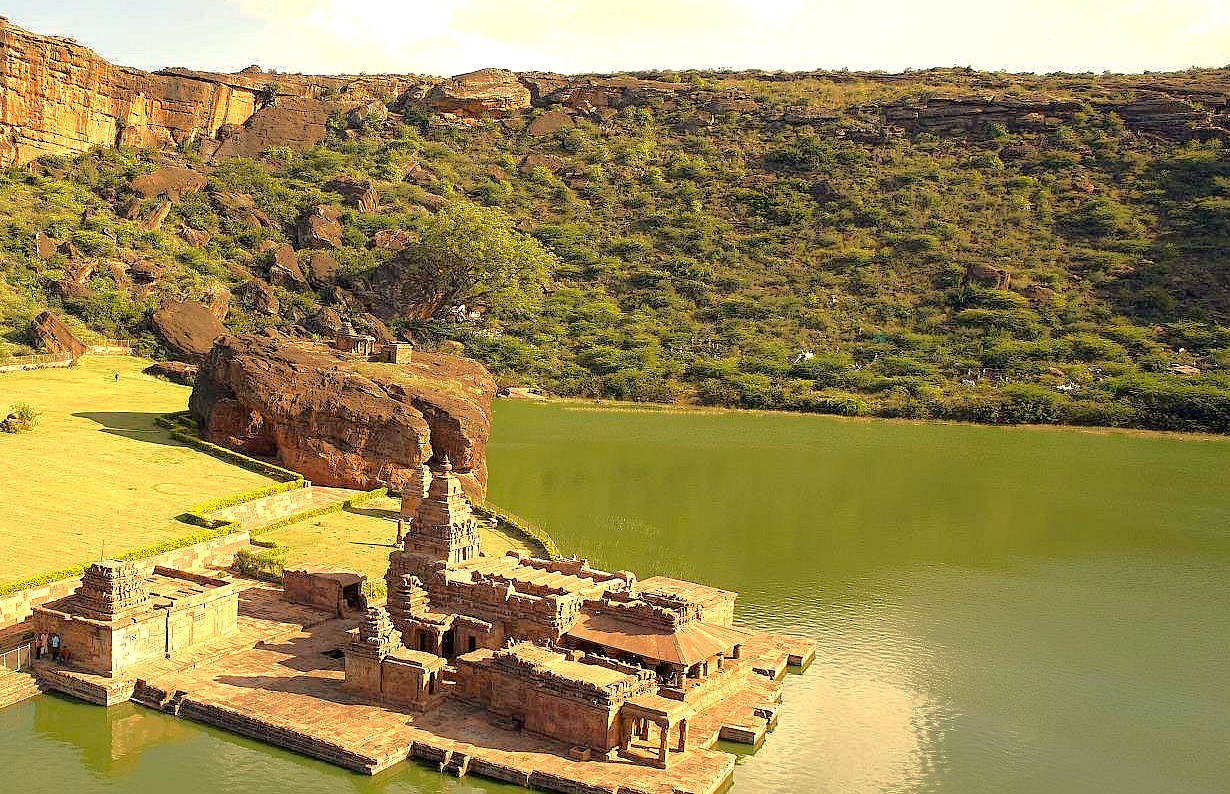 The Bhutanatha group of temples sits majestically on the eastern bank of the sacred Agastya Lake in Badami, Karnataka, India, set against dramatic red sandstone cliffs. This historic Chalukyan-era site is a key attraction near the renowned Pattadakal UNESCO World Heritage site. The Bhutanatha group of temples sits majestically on the eastern bank of the sacred Agastya Lake in Badami, Karnataka, India, set against dramatic red sandstone cliffs. This historic Chalukyan-era site is a key attraction near the renowned Pattadakal UNESCO World Heritage site.