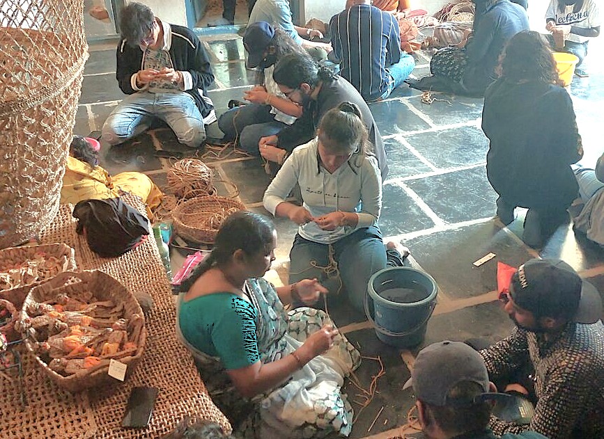 Visitors get a hands-on lesson at the Anegundi Banana Fibre Workshop in Karnataka, India, an immersive cultural experience for tourists exploring the Hampi UNESCO site, a region famed for historical marvels like the Queen's Baths, the magnificent Vittala Temple, and the grand Elephant Stables. Visitors get a hands-on lesson at the Anegundi Banana Fibre Workshop in Karnataka, India, an immersive cultural experience for tourists exploring the Hampi UNESCO site, a region famed for historical marvels like the Queen's Baths, the magnificent Vittala Temple, and the grand Elephant Stables.