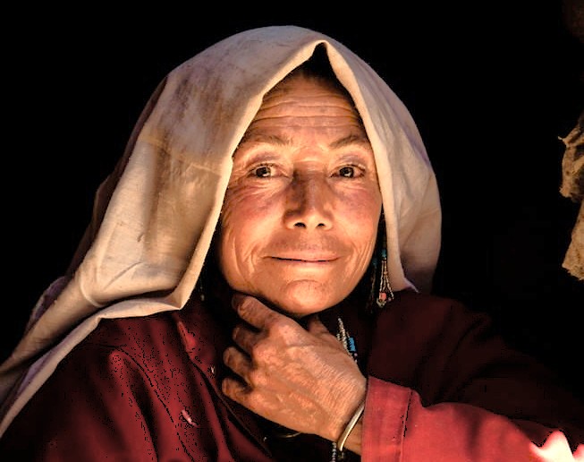 Portrait of a local Kashmiri elder woman at the Bandashar Tomb in Srinagar, Jammu and Kashmir, a cultural site near saffron fields, Aru Valley, and Betaab Valley.