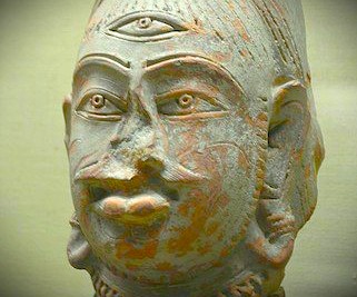 “Ancient sculpted bust with third eye on weathered stone displayed at Bharat Kala Bhavan Museum in Varanasi, Uttar Pradesh, India, near Sarnath Temple Buddha, exemplifying rich classical Indian artistic heritage.”