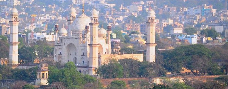 Bibi Ka Maqbara in Aurangabad, Maharashtra, India, showcases Mughal-era white marble beauty near UNESCO-listed Elora and Ajanta Caves, reflecting heritage, architectural grandeur, and cultural significance in a lush urban setting.