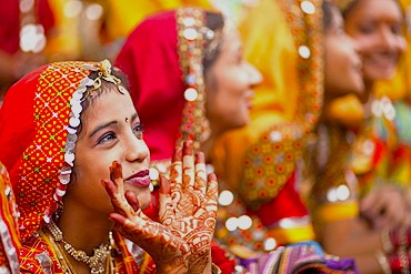 Smiling Rajasthani women adorned with intricate henna and vibrant traditional jewelry celebrate a cultural festival near Junagarh Fort Bikaner in Rajasthan, India, against the golden dunes of the Thar Desert. Smiling Rajasthani women adorned with intricate henna and vibrant traditional jewelry celebrate a cultural festival near Junagarh Fort Bikaner in Rajasthan, India, against the golden dunes of the Thar Desert.