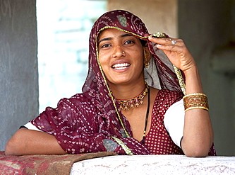 Smiling Rajasthani woman in vibrant traditional attire and intricate jewelry at Junagarh Fort in Bikaner, Rajasthan, India, embodying cultural heritage and desert life against the sands of the Thar Desert. Smiling Rajasthani woman in vibrant traditional attire and intricate jewelry at Junagarh Fort in Bikaner, Rajasthan, India, embodying cultural heritage and desert life against the sands of the Thar Desert.