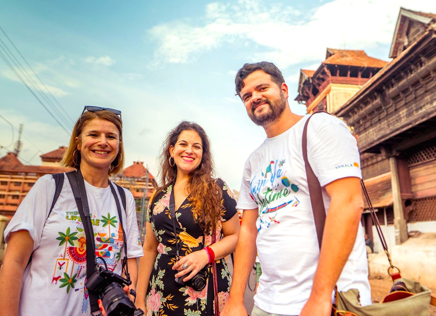 Three smiling travelers explore the vibrant streets of historic Bikaner in Rajasthan’s Thar Desert, India, amidst majestic havelis, bustling bazaars, and ornate temples, capturing rich cultural heritage and desert adventure.