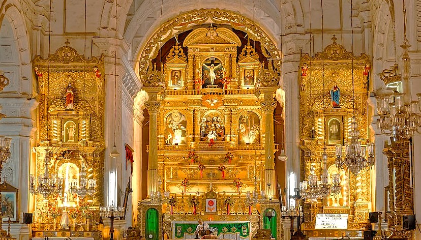The stunning, gilded main altar of the Bom Jesus Basilica, one of the most famous Old Goa Unesco churches, shines with intricate carvings in Goa, India.