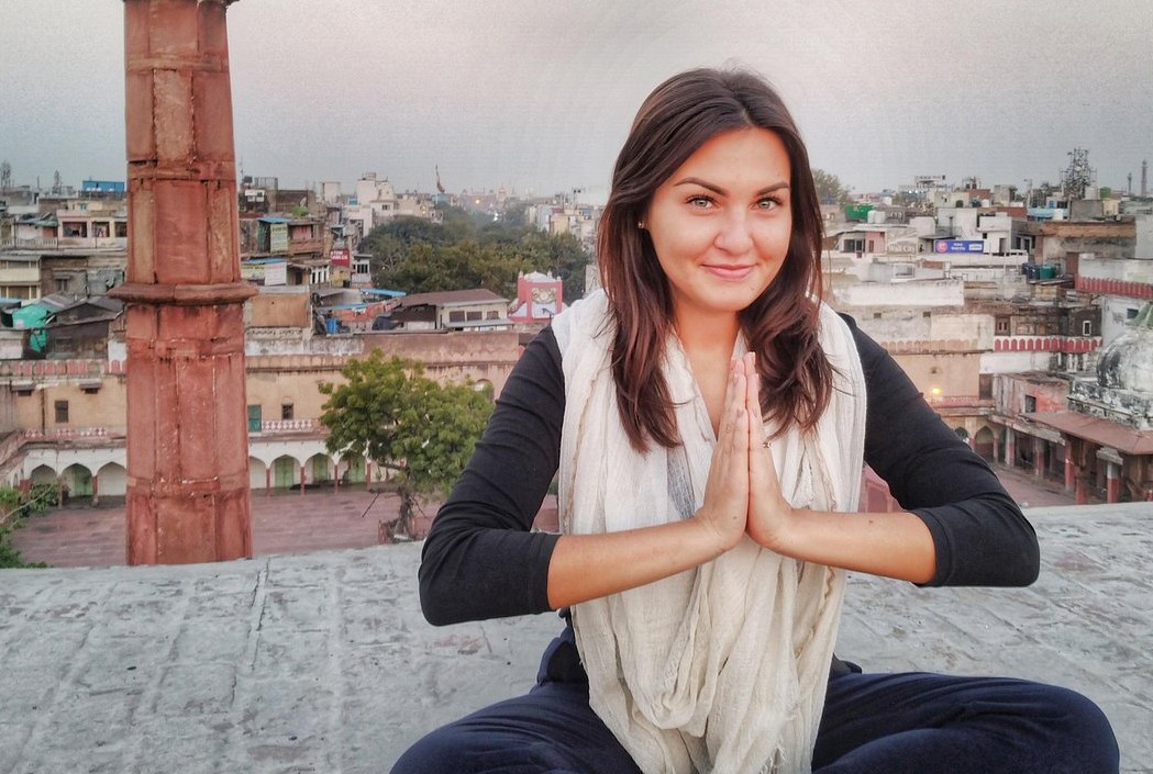 “Tourist in a namaste pose at Mysore, Karnataka, India’s renowned butterfly sanctuary, surrounded by colorful, vibrant winged species, lush gardens, conservation exhibits, and cultural ambiance.”