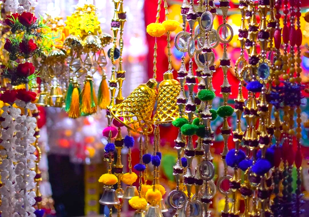 Colorful handcrafted hanging decor in India-Chandi Chowk New Delhi showcases traditional bells, ornate beads, vibrant pompom tassels, festive wall hangings, artisanal metalwork, cultural accessories, authentic decorative souvenirs, bustling market charm. Colorful handcrafted hanging decor in India-Chandi Chowk New Delhi showcases traditional bells, ornate beads, vibrant pompom tassels, festive wall hangings, artisanal metalwork, cultural accessories, authentic decorative souvenirs, bustling market charm.