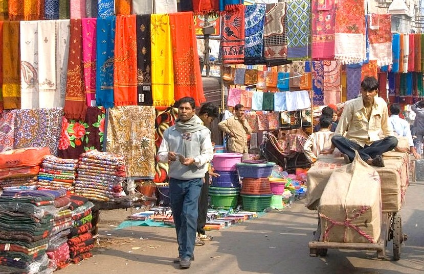 Vibrant street market in India-Chandi Chowk New Delhi showcases colorful textiles, bustling vendors, authentic traditional fabrics, wholesale shopping stalls, historic Old Delhi bazaar atmosphere, lively traffic and South Asian crafts. Vibrant street market in India-Chandi Chowk New Delhi showcases colorful textiles, bustling vendors, authentic traditional fabrics, wholesale shopping stalls, historic Old Delhi bazaar atmosphere, lively traffic and South Asian crafts.