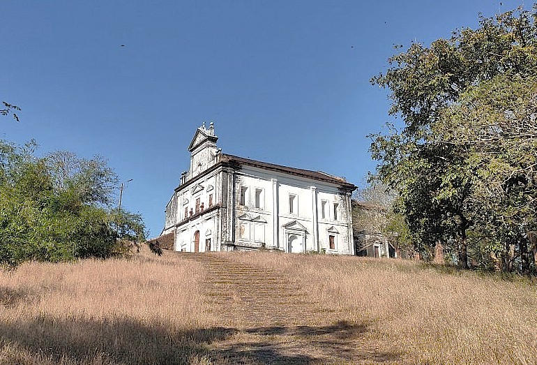 The historic Church of Our Lady of the Rosary in Old Goa, India, a UNESCO site near the Bom Jesus Basilica, pictured from the hill, a popular heritage stop for tourists visiting from Anjuna Beach Flea Market. The historic Church of Our Lady of the Rosary in Old Goa, India, a UNESCO site near the Bom Jesus Basilica, pictured from the hill, a popular heritage stop for tourists visiting from Anjuna Beach Flea Market.