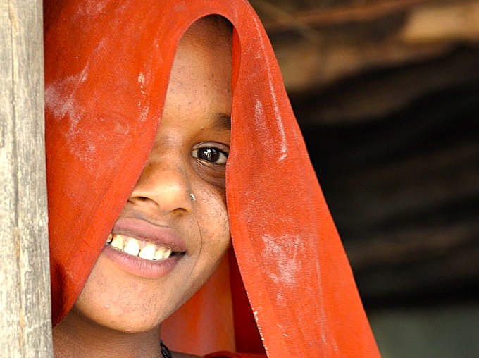 A smiling local girl in Goa, India, represents the vibrant culture tourists see when visiting UNESCO Old Goa sites like the Bom Jesus Basilica and Church of Our Lady of the Rosary, or shopping near Anjuna Beach Flea Market. A smiling local girl in Goa, India, represents the vibrant culture tourists see when visiting UNESCO Old Goa sites like the Bom Jesus Basilica and Church of Our Lady of the Rosary, or shopping near Anjuna Beach Flea Market.