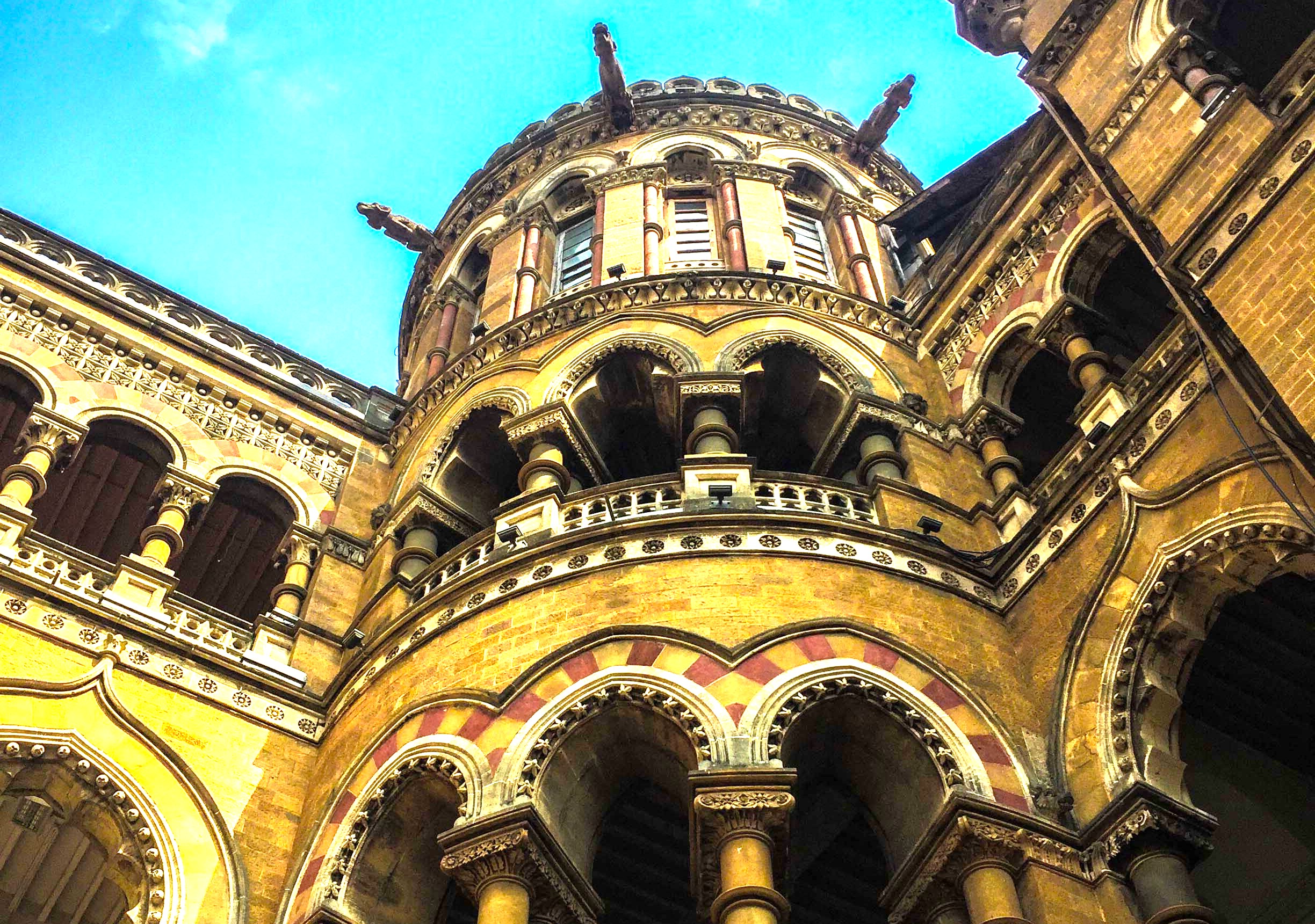 Chhatrapati Shivaji Maharaj Terminus Mumbai. Within this notable structure are various artifacts and spaces that tell stories of the bygone era. The terminus is not just a transport station; it is home to sculptures, murals, and intricately designed stained glass. These elements reflect a unique blend of Indian and Victorian influences, contributing to the station's aesthetic appeal. The entrance is marked by an imposing clock tower - a symbol of time and progress for travelers. This grand building, a Unesco World Heritage site, truly captures the imagination. Chhatrapati Shivaji Maharaj Terminus Mumbai. Within this notable structure are various artifacts and spaces that tell stories of the bygone era. The terminus is not just a transport station; it is home to sculptures, murals, and intricately designed stained glass. These elements reflect a unique blend of Indian and Victorian influences, contributing to the station's aesthetic appeal. The entrance is marked by an imposing clock tower - a symbol of time and progress for travelers. This grand building, a Unesco World Heritage site, truly captures the imagination.