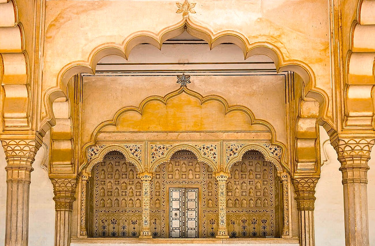  Ornate Unesco-listed City Palace in Jaipur, Rajasthan, India features intricately carved golden arches, floral motifs, historic royal balconies, marble columns, palatial courtyards, exquisite Mughal-Rajasthani ornamentation, and vibrant heritage craftsmanship details.