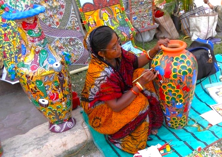 Skilled local artisan in colorful traditional attire hand-paints intricate Madhubani-inspired ceramic vases near the City Palace in Udaipur, Rajasthan, India, showcasing vibrant motifs, cultural heritage, and timeless authentic Rajasthani craftsmanship.  Skilled local artisan in colorful traditional attire hand-paints intricate Madhubani-inspired ceramic vases near the City Palace in Udaipur, Rajasthan, India, showcasing vibrant motifs, cultural heritage, and timeless authentic Rajasthani craftsmanship.