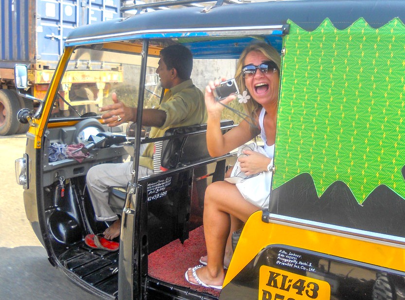Vibrant tuk-tuk ride outside Chhatrapati Shivaji Maharaj Terminus (CSMT) in Mumbai, Mahapradesh, India features a joyful female traveler snapping a selfie with a colorful lively driver amid bustling urban traffic. Vibrant tuk-tuk ride outside Chhatrapati Shivaji Maharaj Terminus (CSMT) in Mumbai, Mahapradesh, India features a joyful female traveler snapping a selfie with a colorful lively driver amid bustling urban traffic.
