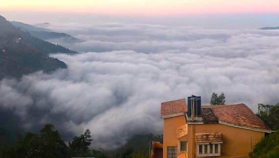 Scenic sunrise clouds blanket the Palani Hills at Coakers Walk in Kodaikanal, Tamil Nadu, South India, offering panoramic mountain vistas and iconic hill station views.
