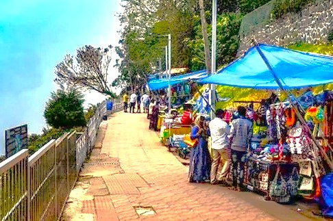 Coaker's Walk in Kodaikanal showcases the vibrant relationship between tourists and local vendors, a popular activity for travelers in India exploring Tamil Nadu from Madurai and Meenakshi Temple or Munnar, which is near the Unesco Western Ghats.