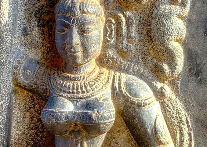 Ancient stone sculpture of a woman with intricate jewelry, Coimbatore, Tamil Nadu, India; historic temple art highlighting Indian heritage and archaeological significance. Ancient stone sculpture of a woman with intricate jewelry, Coimbatore, Tamil Nadu, India; historic temple art highlighting Indian heritage and archaeological significance.
