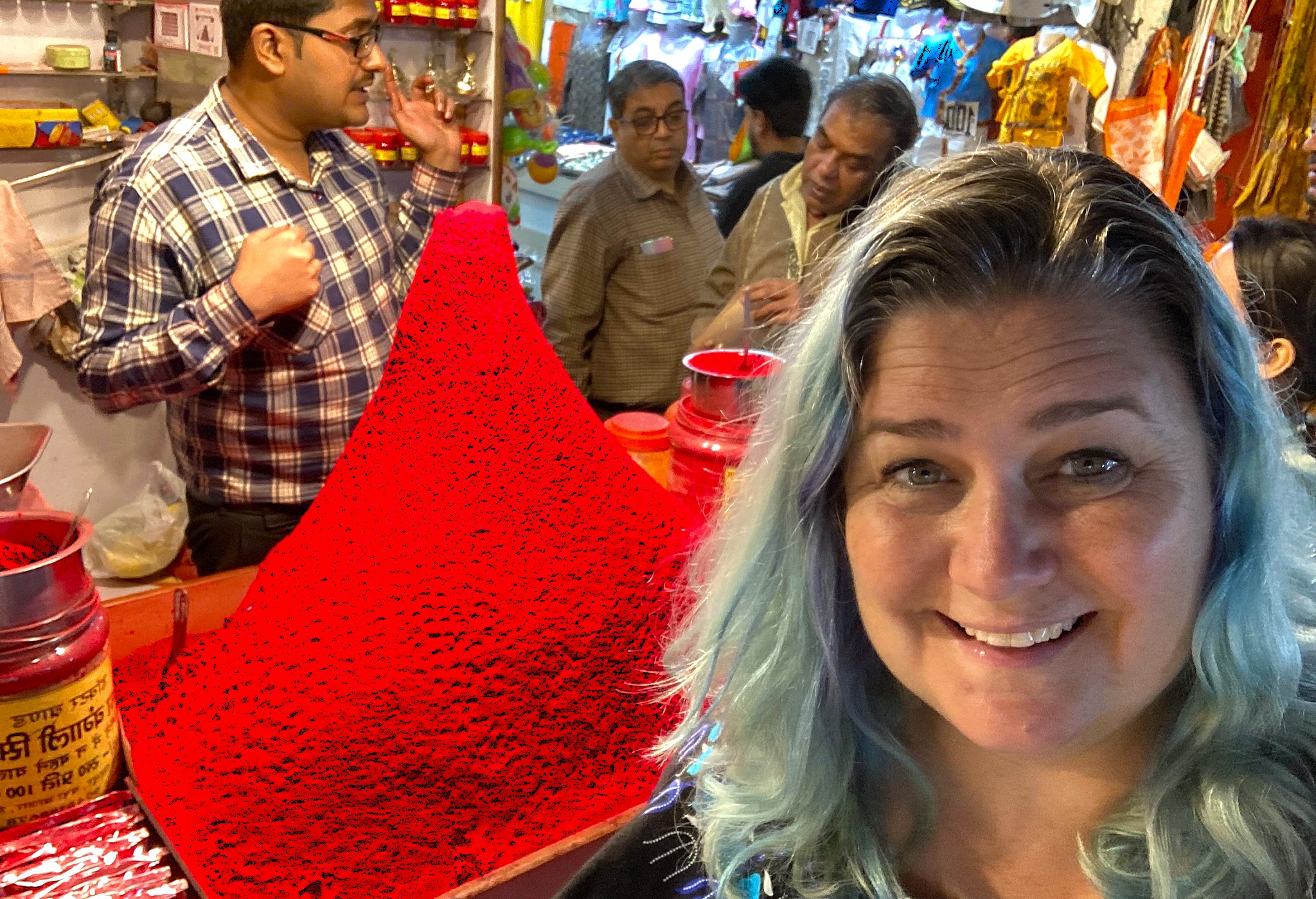 Smiling visitor at vibrant red powder market stall near Patteeswara Temple in Coimbatore, Tamil Nadu, India, capturing local tradition, temple offerings, colorful spices, cultural charm. Smiling visitor at vibrant red powder market stall near Patteeswara Temple in Coimbatore, Tamil Nadu, India, capturing local tradition, temple offerings, colorful spices, cultural charm.