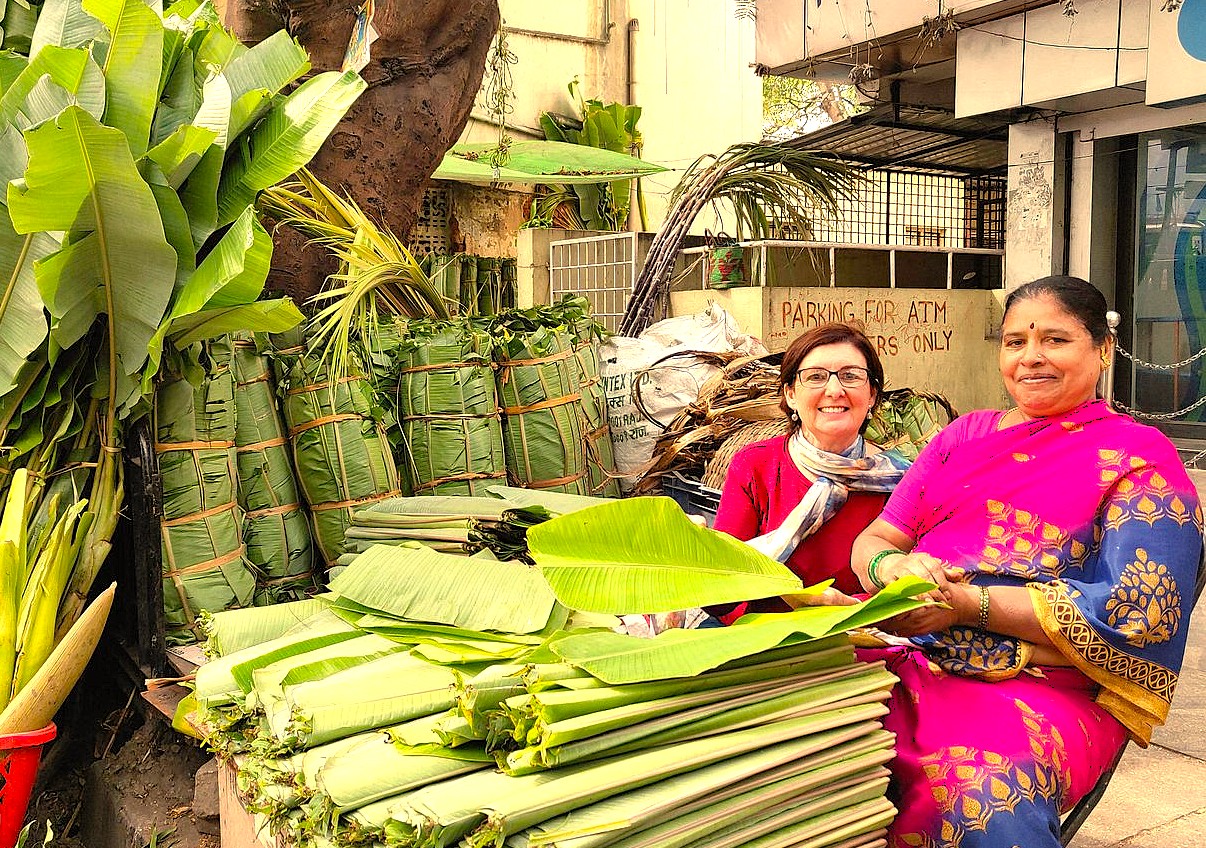 A tourist interacts with a local vendor selling fresh banana leaves on Commercial Street, Bangalore, a key market in Karnataka, India, visited by tourists exploring near Mysore Palace. A tourist interacts with a local vendor selling fresh banana leaves on Commercial Street, Bangalore, a key market in Karnataka, India, visited by tourists exploring near Mysore Palace.