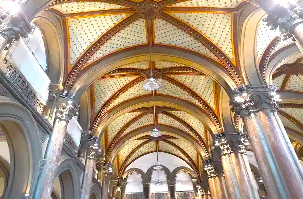 Ornate vaulted interior ceiling at Chhatrapati Shivaji Maharaj terminus (CSMT) in Mumbai, Mahapradesh, India showcases Gothic Revival arches, decorative patterned columns, intricate lighting, heritage railway ambiance, and historic architectural grandeur. Ornate vaulted interior ceiling at Chhatrapati Shivaji Maharaj terminus (CSMT) in Mumbai, Mahapradesh, India showcases Gothic Revival arches, decorative patterned columns, intricate lighting, heritage railway ambiance, and historic architectural grandeur.