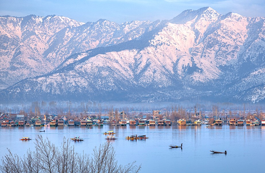 A winter view of Dhal Lake in Srinagar, Jammu and Kashmir, with snow-capped mountains, near the Light and Sound show, saffron fields, Aru Valley, and Betaab Valley.