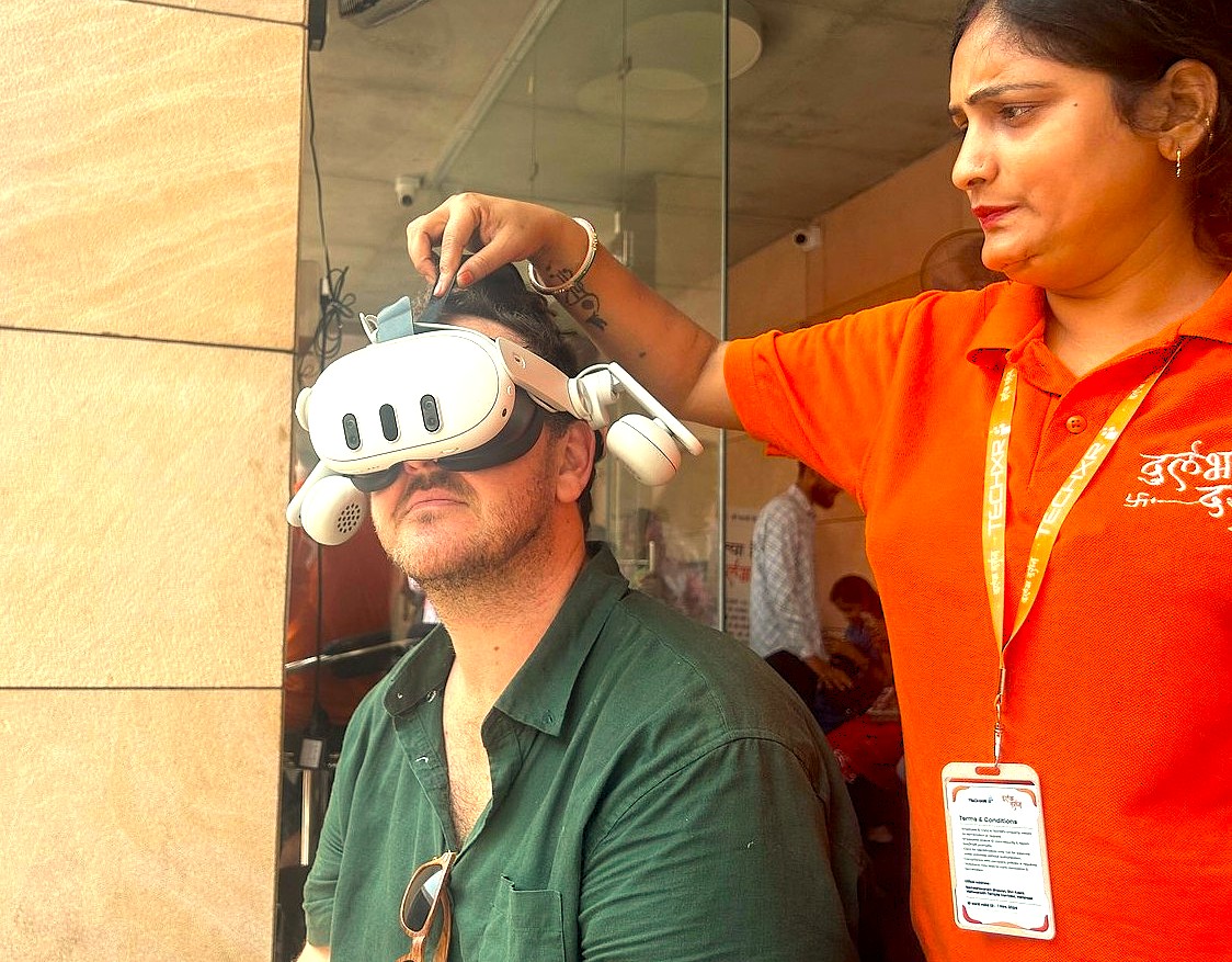 A staff member at the Durlabh Darshan Kendra in Varanasi, Uttar Pradesh, India, builds a helpful relationship by assisting a person with a VR headset near the Sarnath UNESCO site. A staff member at the Durlabh Darshan Kendra in Varanasi, Uttar Pradesh, India, builds a helpful relationship by assisting a person with a VR headset near the Sarnath UNESCO site.